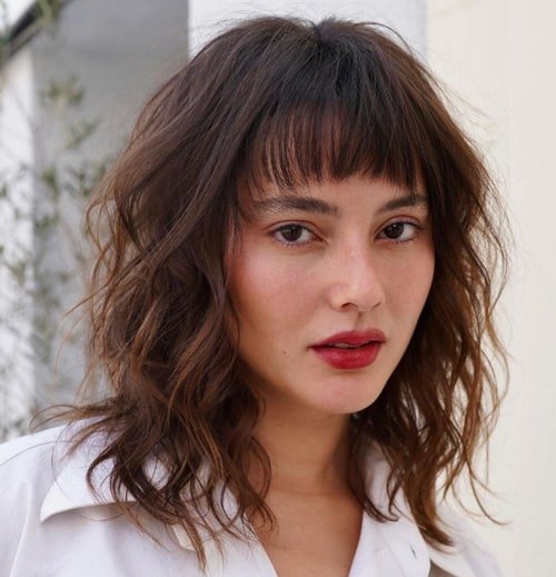 Choppy Bangs and Layered Waves Playful Medium Haircuts 2024